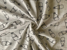 Load image into Gallery viewer, Organic Cotton Muslin Baby Swaddle Cloth with Black milk bottle pattern on white.
