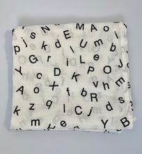 Load image into Gallery viewer, Organic Cotton Muslin Baby Swaddle Cloth with Black letters/alphabet pattern on white.
