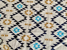 Load image into Gallery viewer, Organic Cotton Muslin Swaddle cloth with geometric Aztec print design in blue/black/gold on white background.
