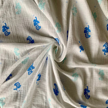 Load image into Gallery viewer, Organic Cotton Muslin Swaddle cloth with blue and turquoise elephant design on white. Cloth is twisted neatly to show design.
