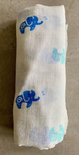 Load image into Gallery viewer, Organic Cotton Muslin Swaddle cloth with blue and turquoise elephant design on white. Cloth is rolled neatly to show design.
