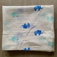 Load image into Gallery viewer, Organic Cotton Muslin Swaddle cloth with blue and turquoise elephant design on white. Cloth is folded neatly on table.
