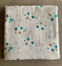 Load image into Gallery viewer, Organic Cotton Muslin Cloth with blue and gold stars varying shades on white background. Cloth is folded neatly to show design.
