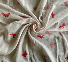 Load image into Gallery viewer, Organic Cotton Muslin Baby Swaddle Cloth with pink and lilac butterflies on white. Cloth is twisted decoratively.
