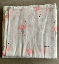 Load image into Gallery viewer, Organic Cotton Muslin Baby Swaddle Cloth with delicate pink flamingo pattern on white. Cloth folded neatly on table.
