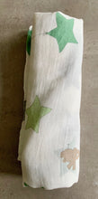 Load image into Gallery viewer, Organic Cotton Muslin Baby Swaddle Cloth with varying shades of green/grey star balloons and floating brown elephant pattern on white.
