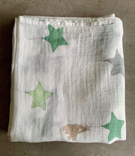 Load image into Gallery viewer, Organic Cotton Muslin Baby Swaddle Cloth with varying shades of green/grey star balloons and floating brown elephant pattern on white.
