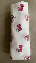 Load image into Gallery viewer, Organic Cotton Muslin Baby Swaddle Cloth with Pink Hello kitty and bows pattern on white. Rolled neatly on table.
