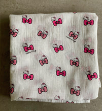 Load image into Gallery viewer, Organic Cotton Muslin Baby Swaddle Cloth with Pink Hello kitty and bows pattern on white. Folded neatly on table.
