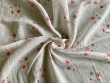 Load image into Gallery viewer, Organic Cotton Muslin Baby Swaddle Cloth with pink and gold star pattern on white.
