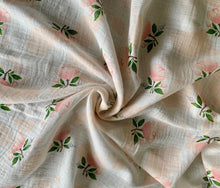 Load image into Gallery viewer, Organic Cotton Muslin Baby Swaddle Cloth with delicate floral pink/peach rose and cotton pattern on white.
