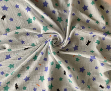 Load image into Gallery viewer, Organic Cotton Muslin Baby Swaddle Cloth with varying sizes of small green and blue stars and small black bears pattern on white.
