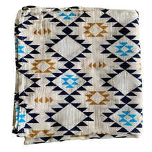 Load image into Gallery viewer, Organic Cotton Muslin Swaddle cloth with geometric Aztec print design in blue/black/gold on white.
