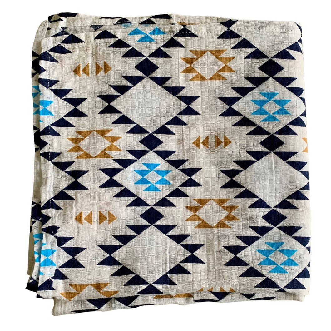 Organic Cotton Muslin Swaddle cloth with geometric Aztec print design in blue/black/gold on white.