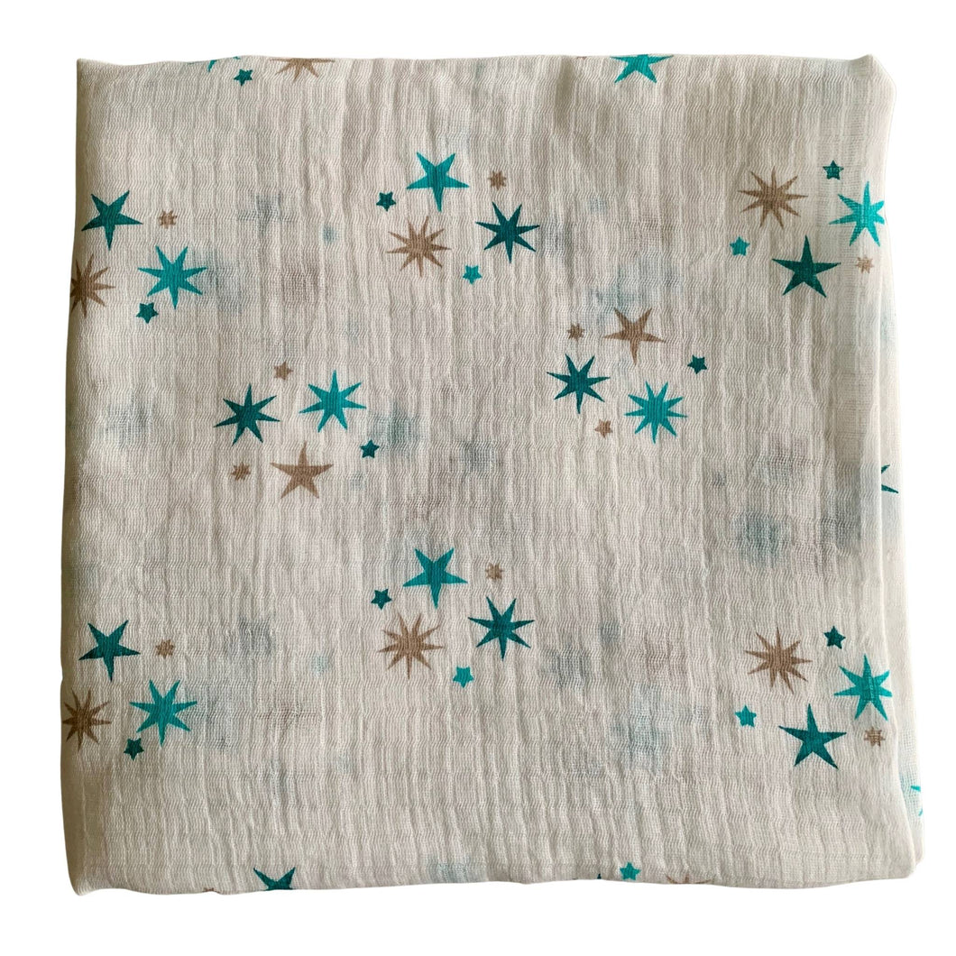 Organic Cotton Muslin Cloth with blue and gold stars varying shades on white background. 