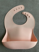 Load image into Gallery viewer, Silicone Bib BPA Free in light peach/butternut squash colour and 4 buttons with large crumb catcher scoop.
