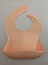 Load image into Gallery viewer, Silicone Bib BPA Free in light peach/butternut squash colour and 4 buttons with large crumb catcher scoop.
