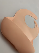 Load image into Gallery viewer, Silicone Bib BPA Free in light peach/butternut squash colour and 4 buttons with large crumb catcher scoop.
