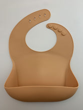 Load image into Gallery viewer, Silicone Bib BPA Free in light brown/camel colour and 4 buttons with large crumb catcher scoop.
