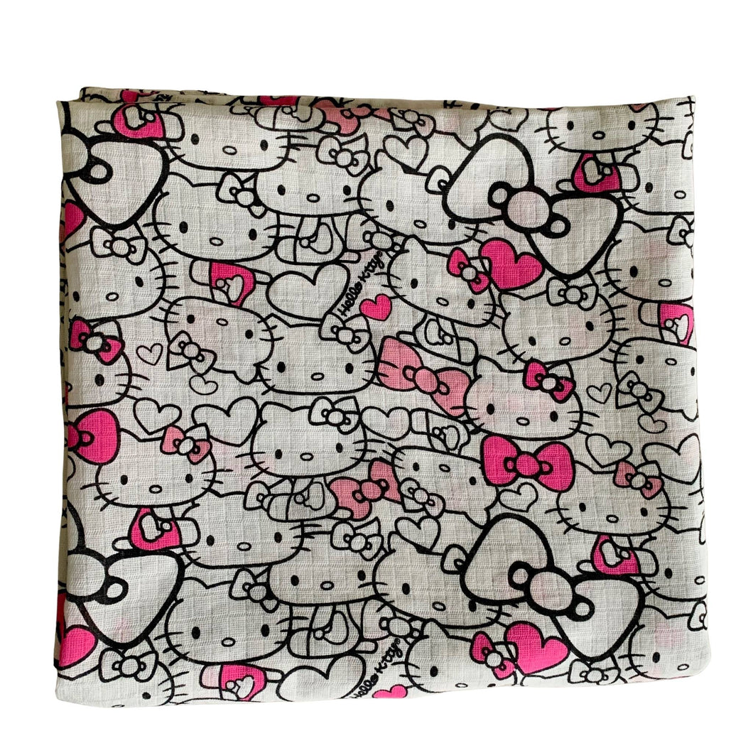 Organic Cotton Muslin Baby Swaddle Cloth with Pink and Black Hello kitty pattern on white.