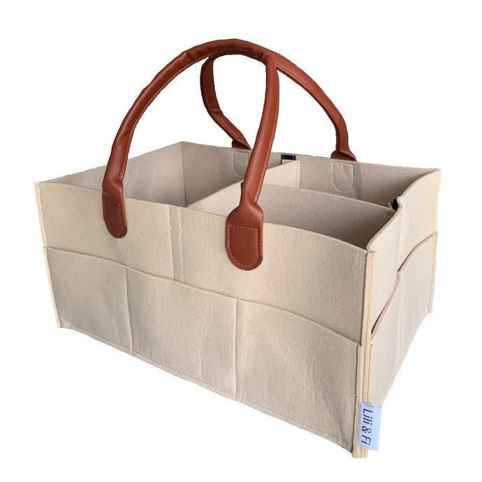 beige nude nappy caddy organised with brown pu leather handles against white background