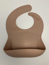 Load image into Gallery viewer, Silicone Bib BPA Free in a light brown/nude colour and 4 buttons with large crumb catcher scoop.
