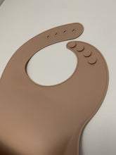 Load image into Gallery viewer, Silicone Bib BPA Free in a light brown/nude colour and 4 buttons with large crumb catcher scoop.
