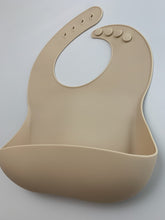 Load image into Gallery viewer, Silicone Bib BPA Free in a light brown/nude colour and 4 buttons with large crumb catcher scoop.
