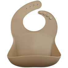 Load image into Gallery viewer, Silicone Bib BPA Free in a light brown/nude colour and 4 buttons with large crumb catcher scoop.
