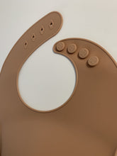 Load image into Gallery viewer, Silicone Bib BPA Free in a medium brown colour and 4 buttons with large crumb catcher scoop.
